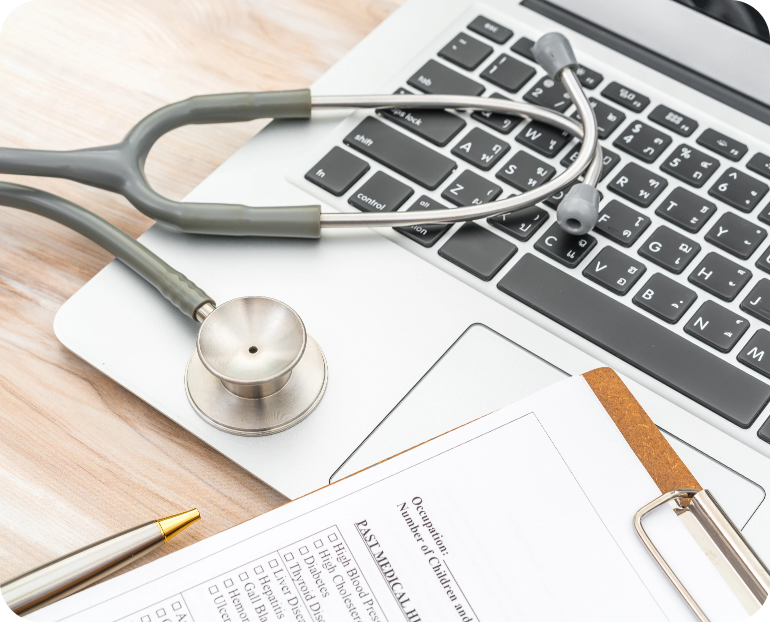 stethoscope laptop and document on clipboard